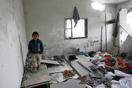 A Palestinian child stands inside his home in the Jabalya refugee camp, damaged during an Israeli incursion and airstrikes which left about 115 Palestinians dead in Gaza over five days.