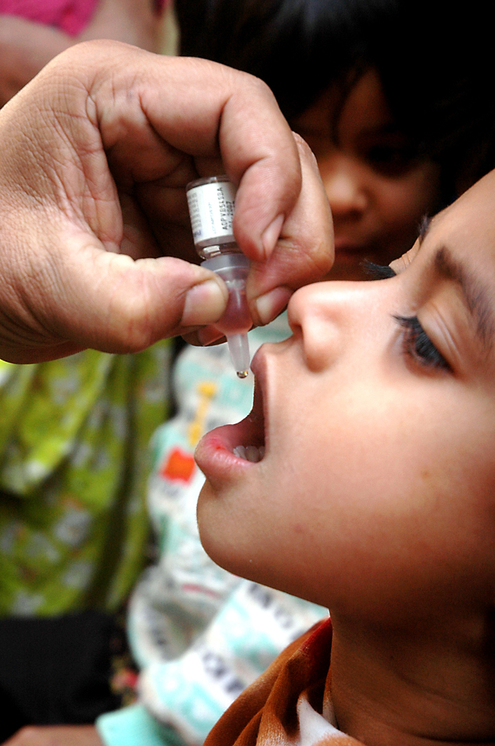 A young child receives polio drops in Pakistan. Pakistan is one of four countries in the world today where the disease remains endemic - the others being Afghanistan, Nigeria, and India.