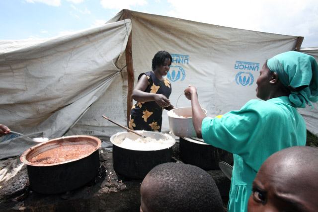 Displaced families receive food aid at the Nakuru IDP camp, April 2008. At least 350,000 were displaced during the post election violence in Kenya, which also claimed the lives of more than 1,200 people.