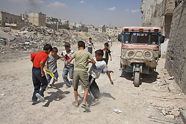 Kids play in a neighbourhood populated mostly by Iraqi refugees. Because refugees are not allowed to work in Syria, children often must take informal jobs to help support their families.