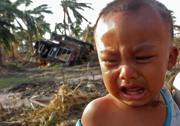 A baby cries as he is held by his father in Dedaye township, some 48 kilometers south of Yangon, Myanmar on May 9, 2008.
PHOTO: courtesy of AFP