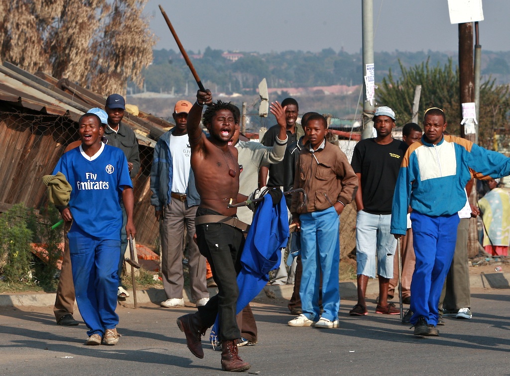 Residents of Ramaphosa informal settlement in Reiger park near Benoni east of Johannesburg took to the streets again waving sticks, knives and axes as they continue to hunt down beat and kill foreigners around the area. South Africa. May 2008