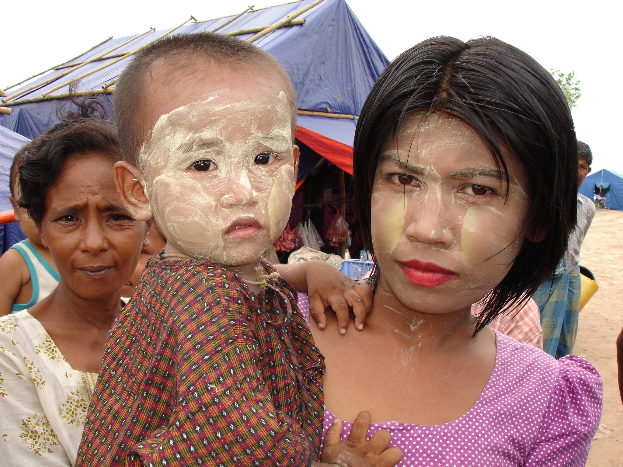 A young mother and her child at a displaced persons camp on the outskirts of Labutta, southern Myanmar. Thousands of people were displaced by Cyclone Nargis when it slammed into the Ayerwadyy delta in May 2008, leaving more than 138,000 dead or missing.