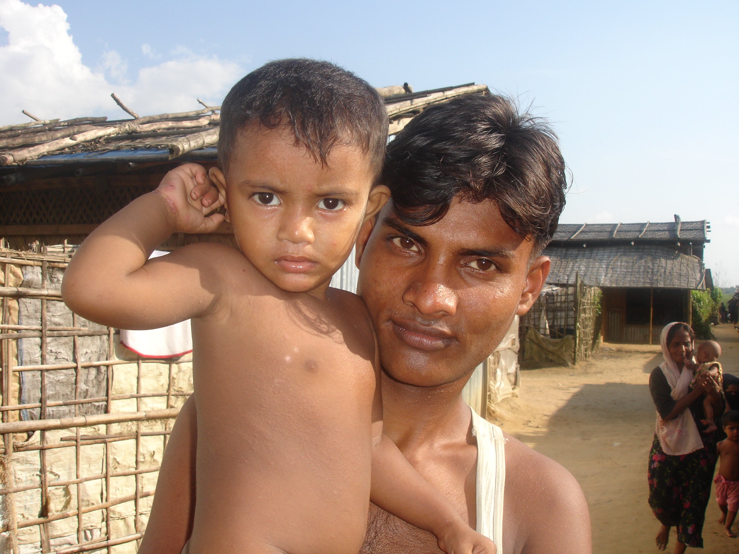 A young Rohingya man and his son at the Kutupalong refugee camp in southern Bangladesh. There are upwards 200,000 Rohingya refugees in the country, about 28,000 of whom are documented and live at two government-run camps in the area.