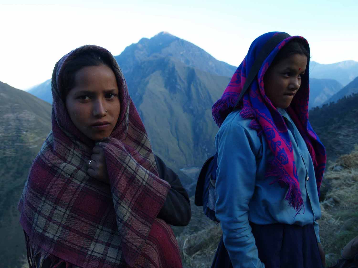 Young girls return home from school in Maila, Humla District, Mid-West Nepal. Many students trek on an empty stomach two to three hours over steep terrain to get to and from school and are left little time to study.