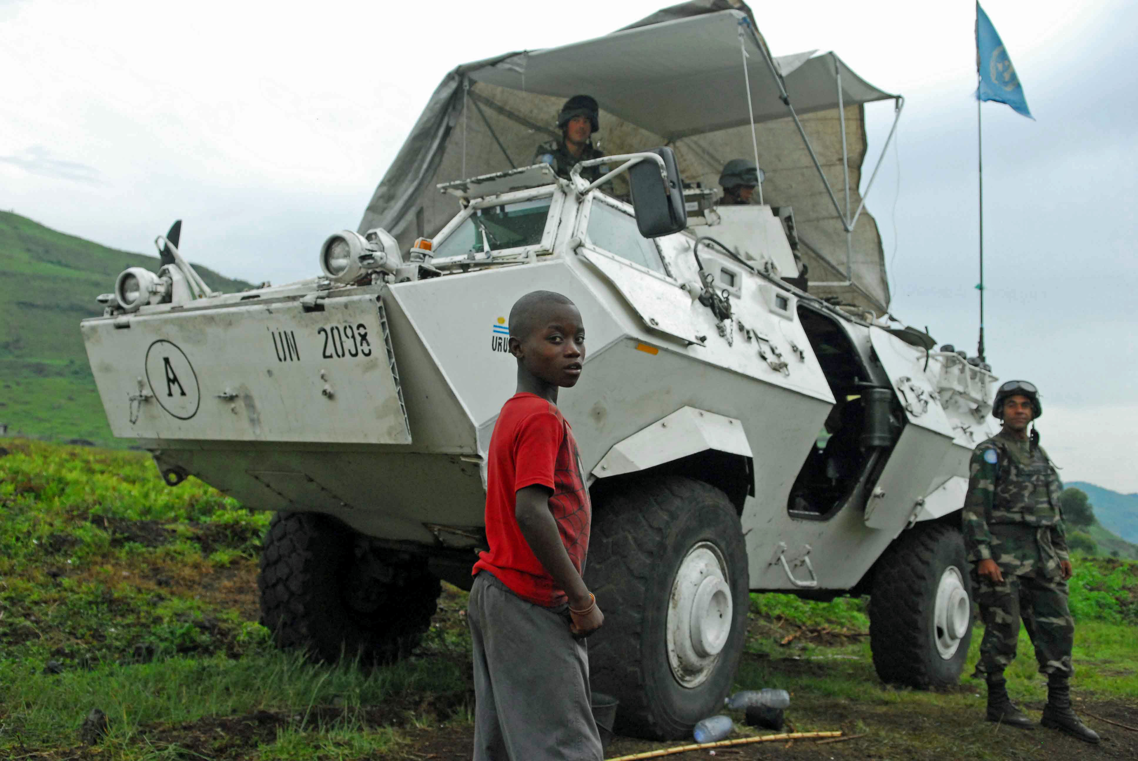 A Congolese boy stands in front of an armored-personnel carrier manned by soldiers from the UN’s peacekeeping mission in Congo, known as MONUC, outside of the eastern city of Goma taken on Nov. 2, 2008