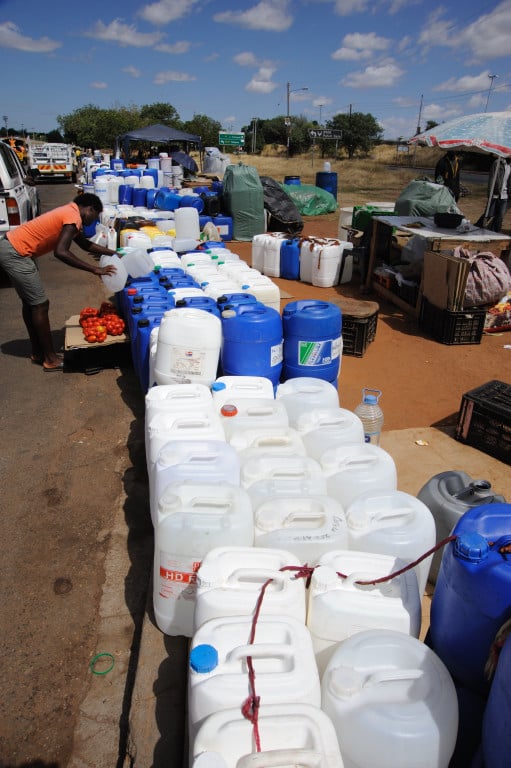 Infromal traders selling plastic containers for fuel and water in the