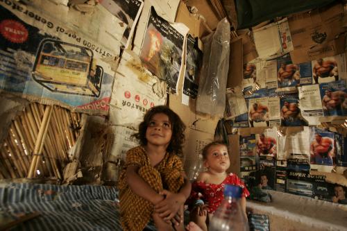 Displaced children sit in their makeshift shelter in an abandoned government building in Baghdad in 2008