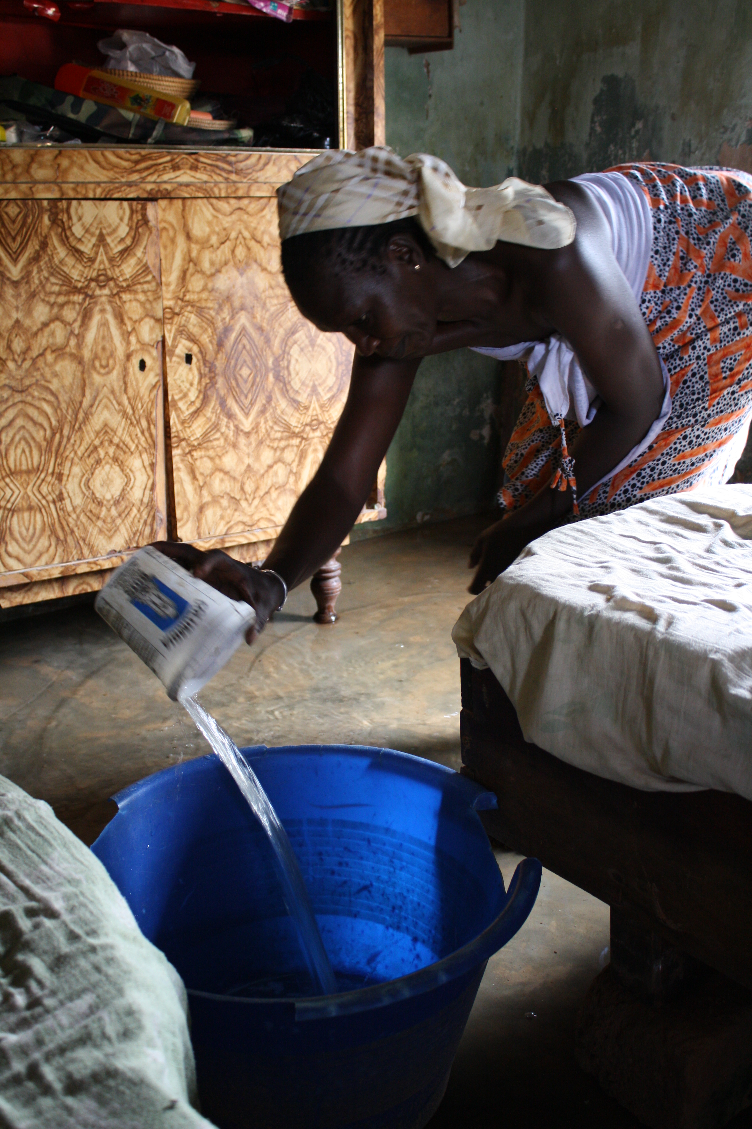 Senegalese gear up for likely flooding A woman in Dakar's Pikine area scoops up water in her flooded bedroom. August 2009