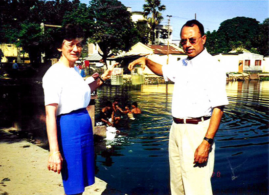 Rita Colwell and colleague Anwar Huq display water samples of filtered (left) and unfiltered water. Colwell and her team found that filtering drinking water through four or more folds of sari cloth - a material widely available southern Asia – helps to 