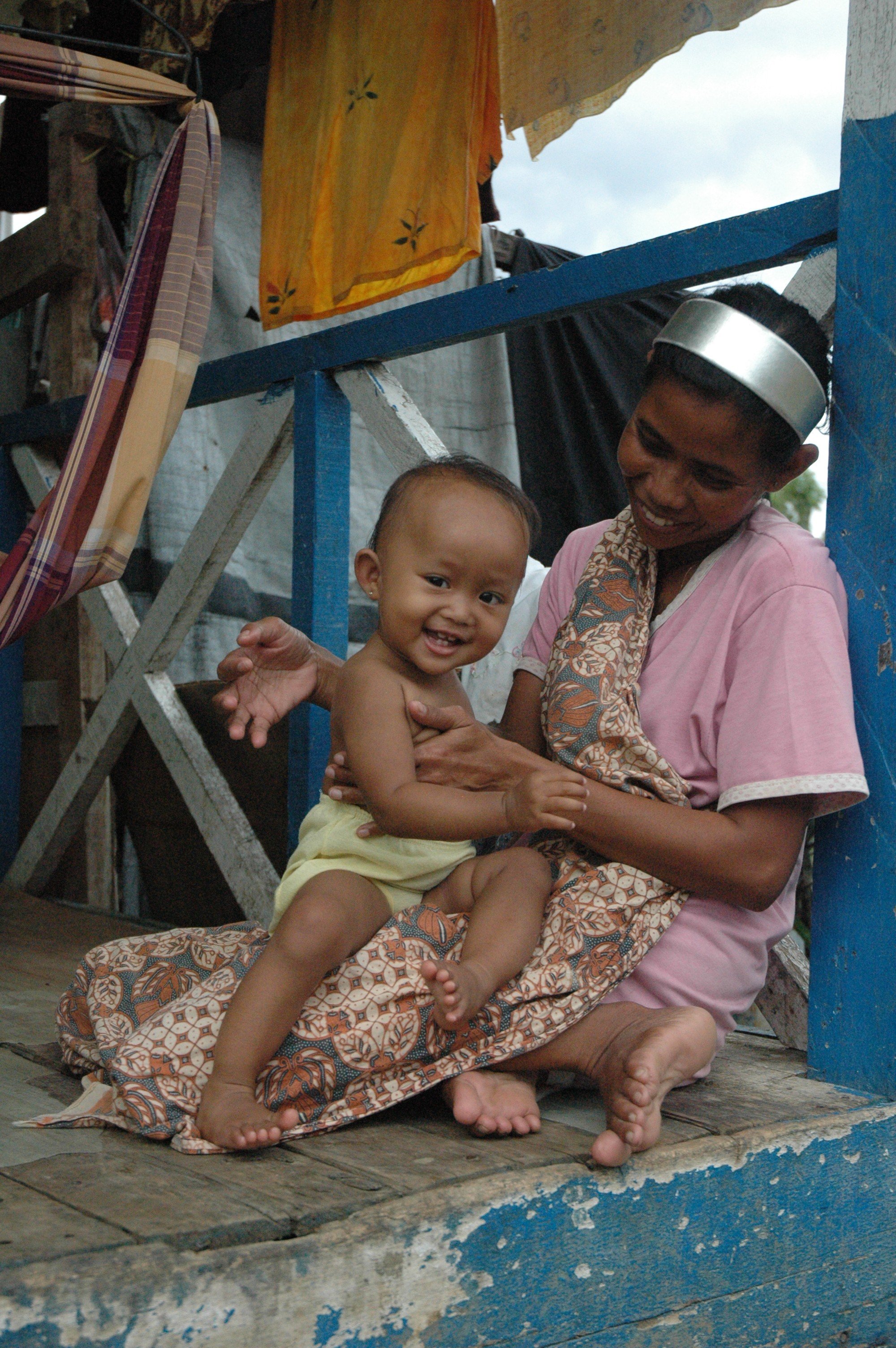 A mother and child at Barak Bakoi, a barrack-like settlement in Banda Aceh, where residents continue to away permanent housing five years on. An estimated 160,000 people lost their lives to the 26 December 2004 tsunami in Aceh