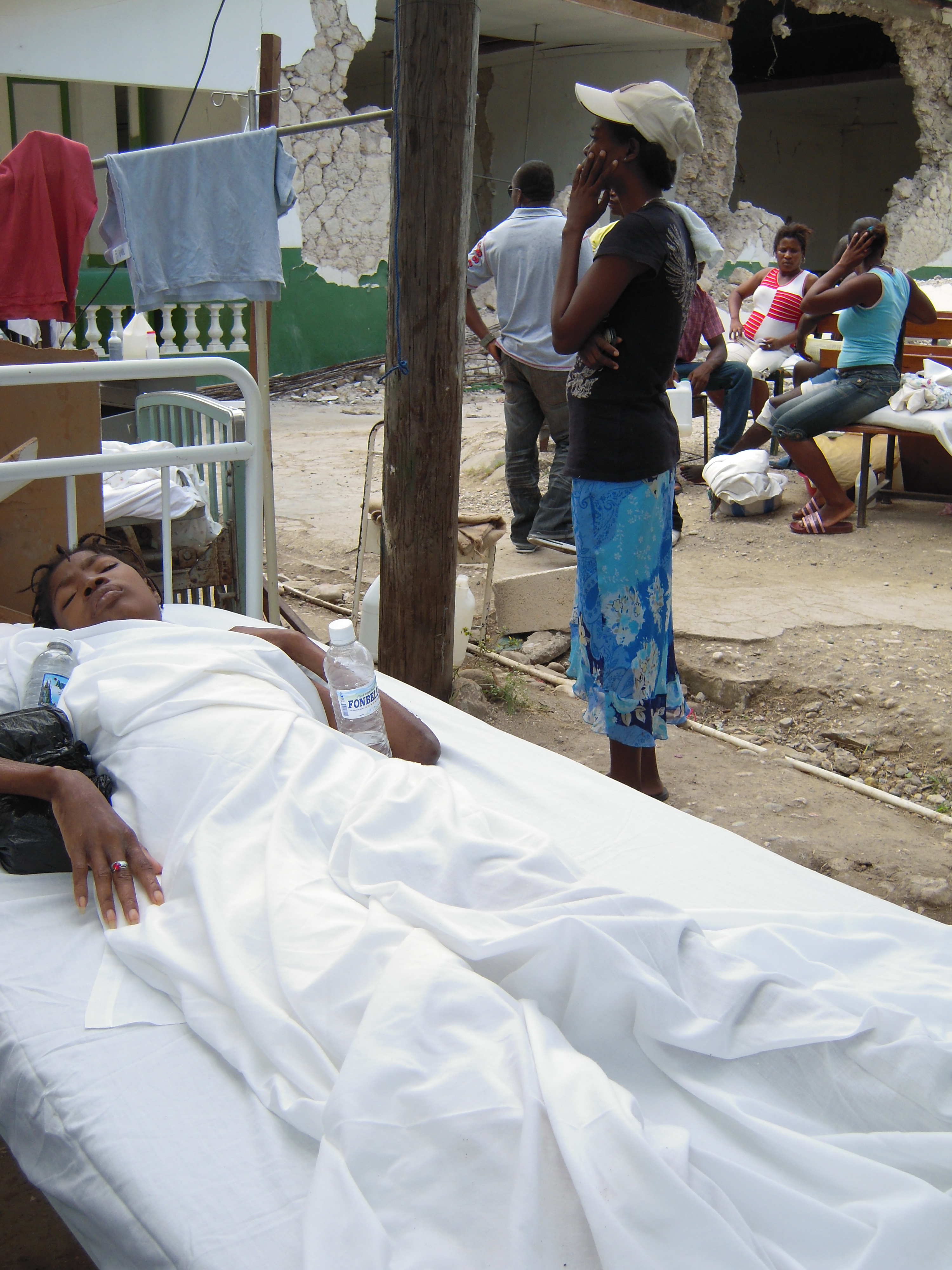 Patient care moves outdoor at debris-strewn reference hospital in southeast Haiti, Jacmel