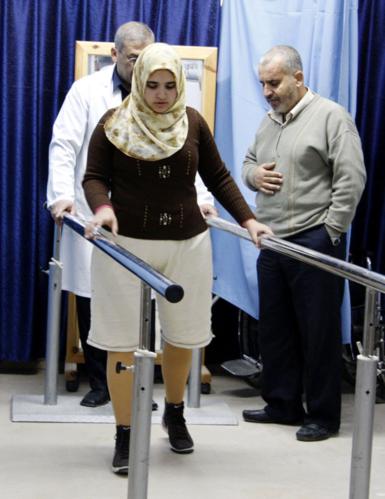 Jamila al-Habbash, 15, lost both her legs in a missile strike by an unmanned Israeli drone as she played on the roof of her home in eastern Gaza. She receives training to wear her artificial legs at the Artificial Limb and Polio Centre in Gaza