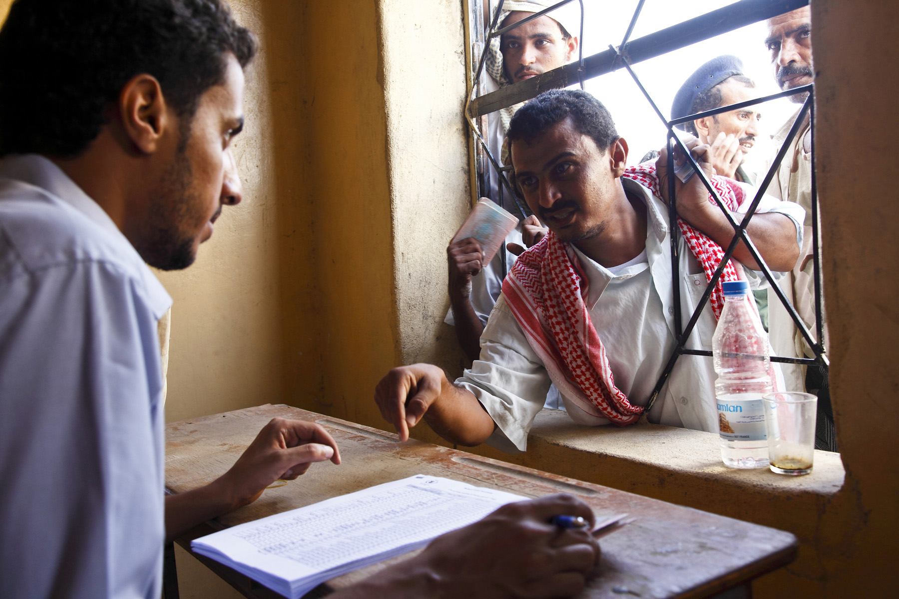 A man living outside Mazrak camp registers to receive his allowance of grain, beans and cooking oil from a World Food Programme distribution centre in the local capital, Harad. August 2009