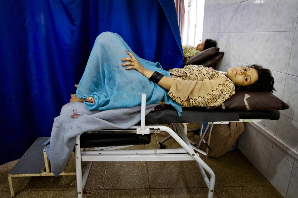 A woman in labour lies in pain in the obstetrics ward at Mirwais Hospital in Kandahar, Afghanistan