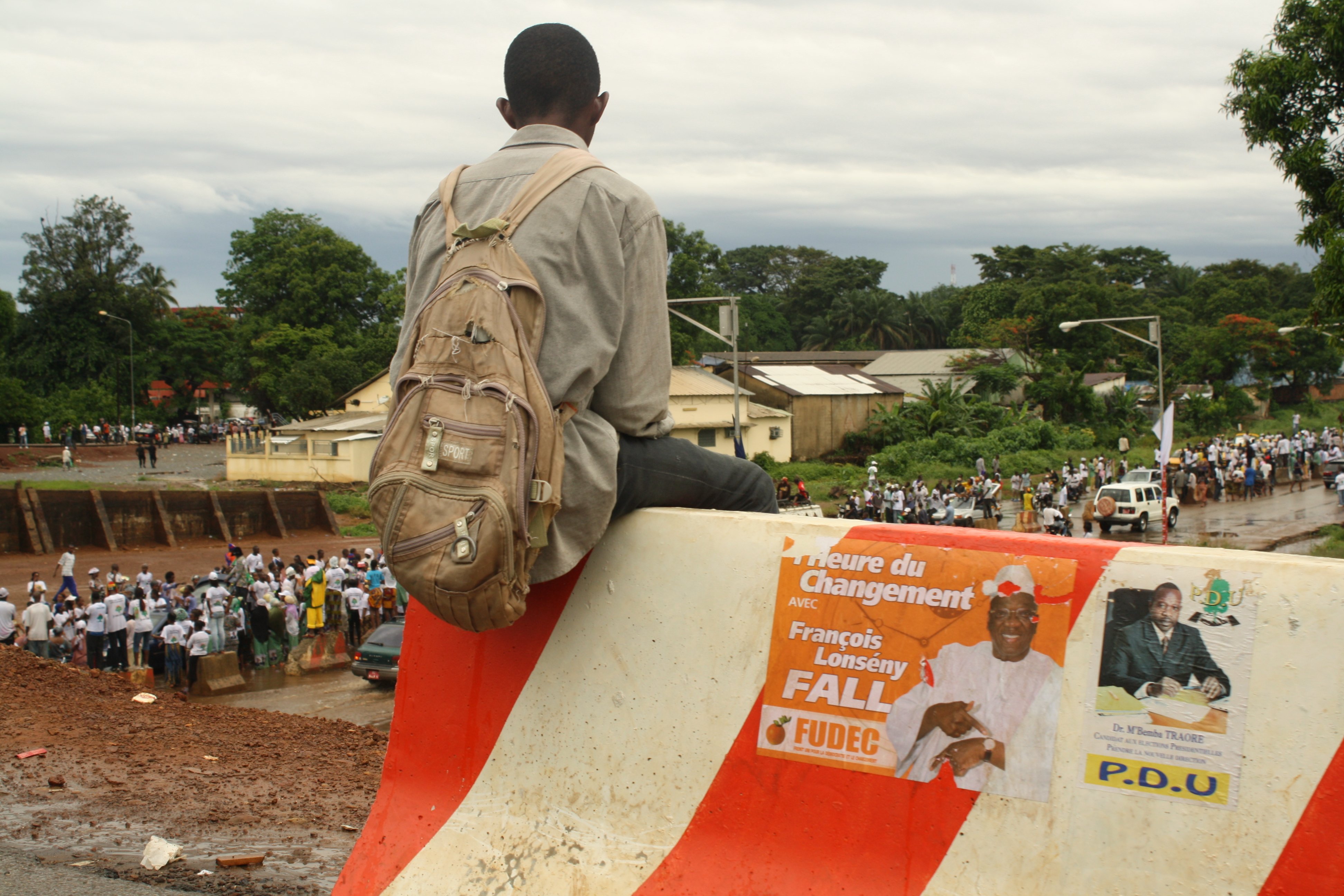 Youth watches in the Guinea capital, Conakry, a presidential candidate's rally days ahead of 27 June poll 