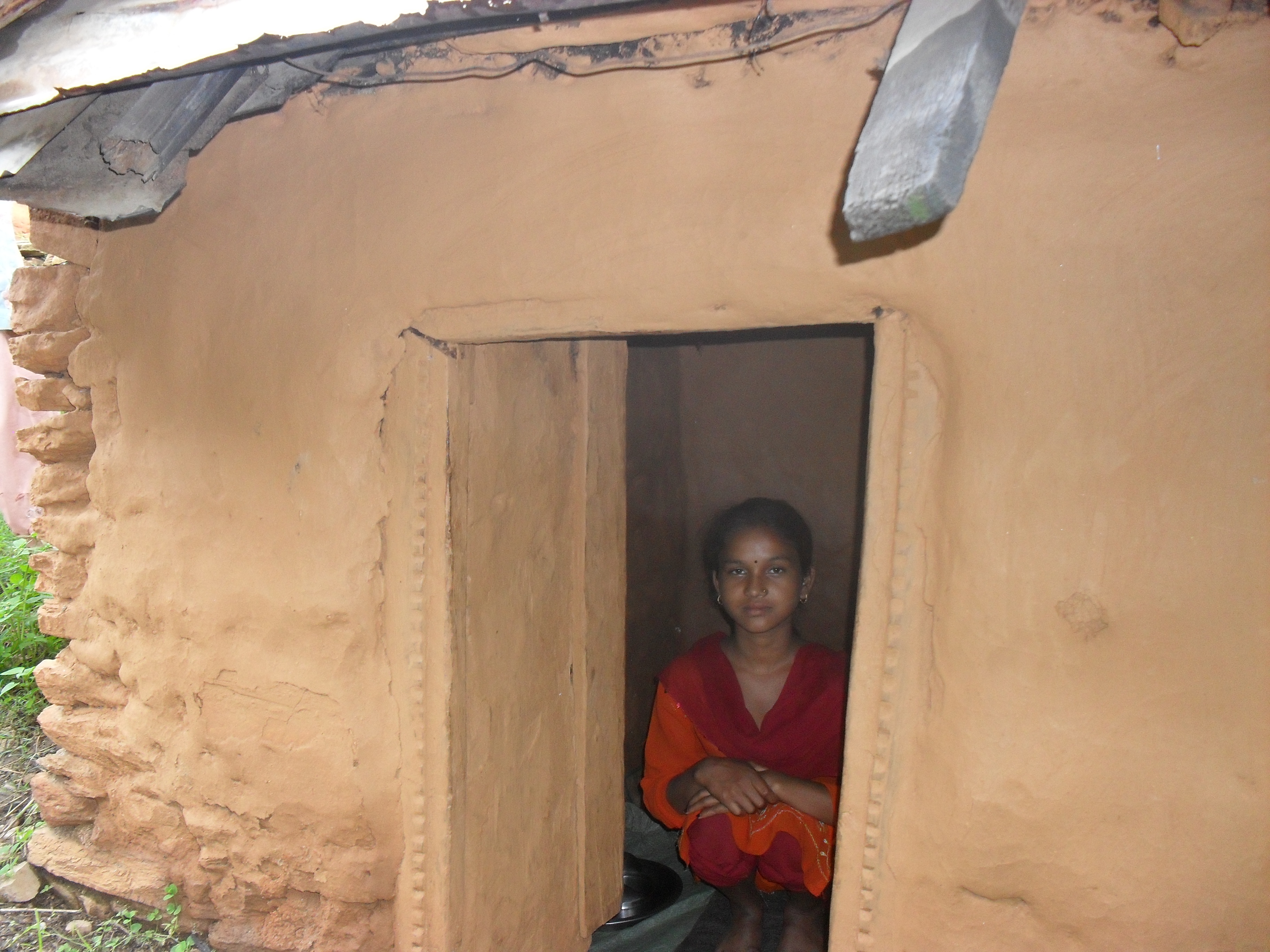 Kamala Vishwarkarmas sits inside her goth, where she has been staying alone during the week of her monthly period.  'Chhaupadi’, the Nepalese practice of segregating menstruating women from their houses and men, was outlawed by Nepal's supreme court in 