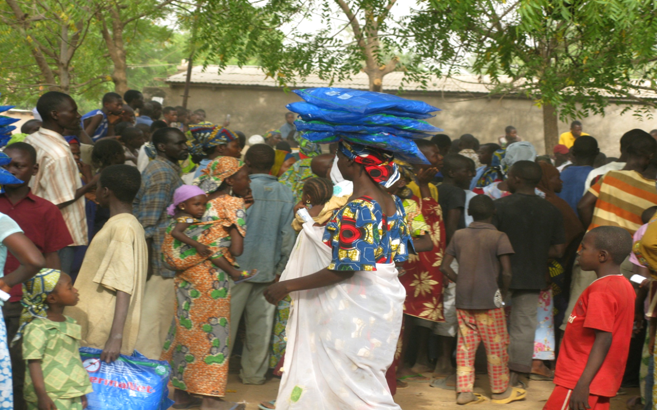 Families picking up insecticidetreated mosquito nets in northern