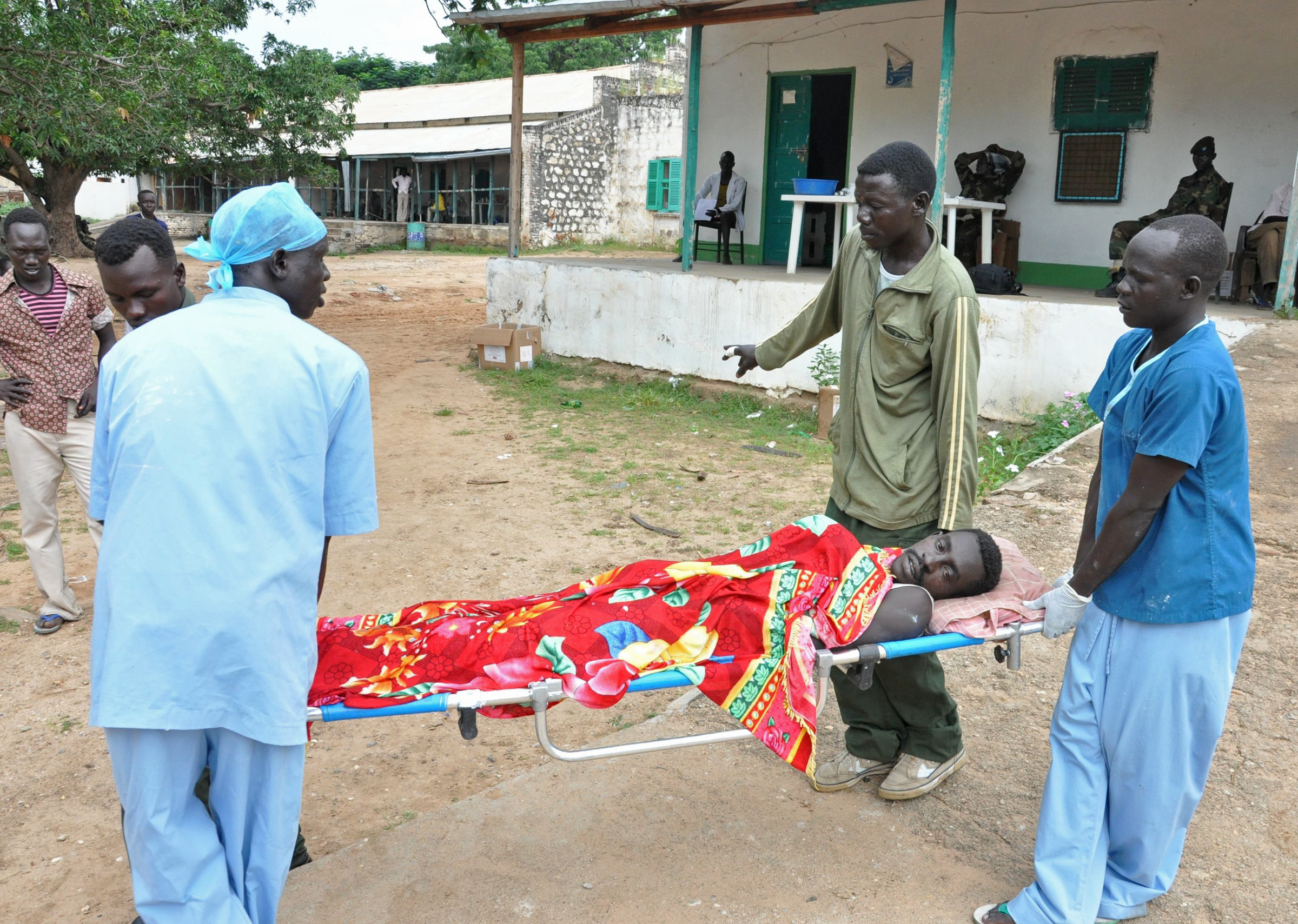 A man being moved out of the operating theatre where he has been treated for shrapnel wounds in Kurmuk hospital. Ketamine is being used as an anaesthetic and the man's wailing echoed hauntingly around the complex