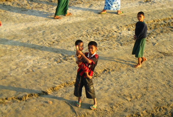 Children look to the camera along the Ayeyarwady River which flows through Myanmar's so called Dry Zone. Two major rivers, the Ayeyarwady and the Chindwin flow through the region from North to South connecting it to the Deltaic region in the South