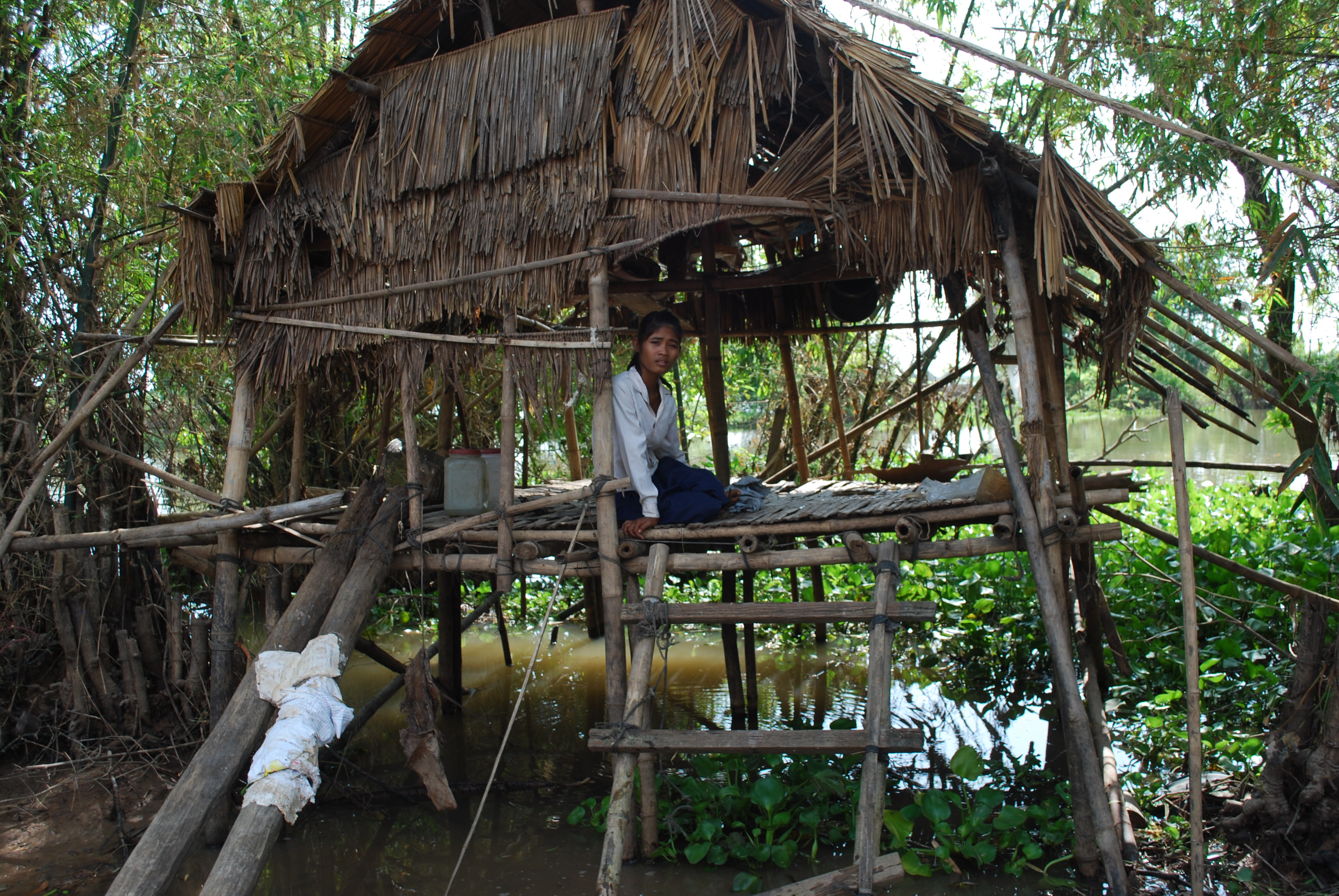 Orphan Soy Chet, 16 at her home in Anlong Chrey village, Kampong Cham province, Cambodia. She is unsure whether she will be able to complete primary school as her neighbours are no longer able to assist after the floods submerged their village and destroy