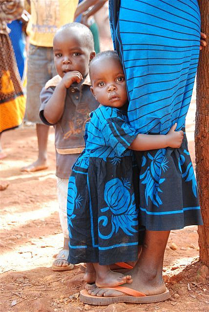 Little girl holding her mother at Mtabila camp for Burundian refugees