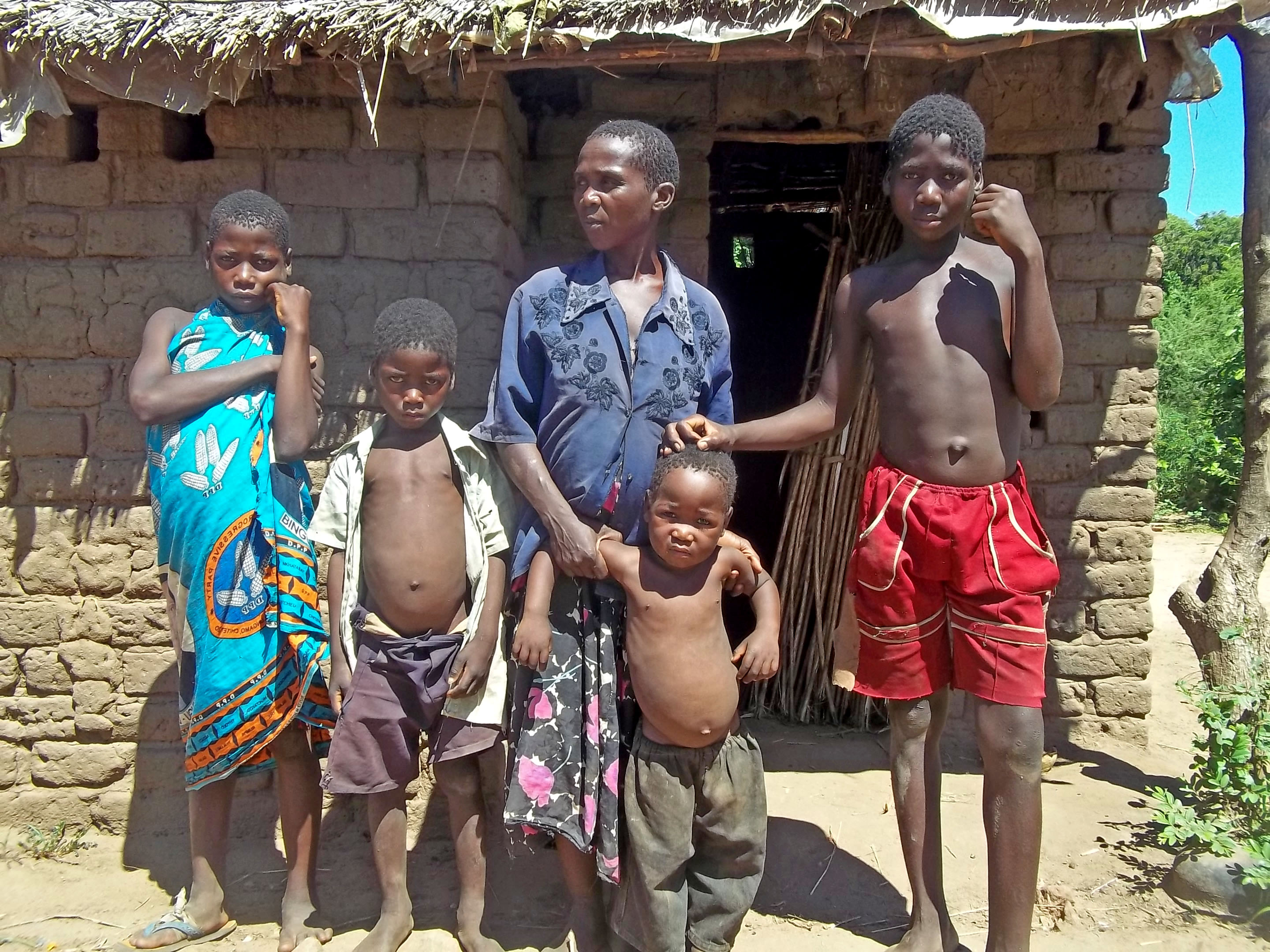 Mary Lyford with four of her children in front of their home in Mbande Village in southern Malawi’s Chikhwawa district. Erratic rains meant Lyford harvested nothing from the family’s one hectare plot this year. Food assistance from the government ende