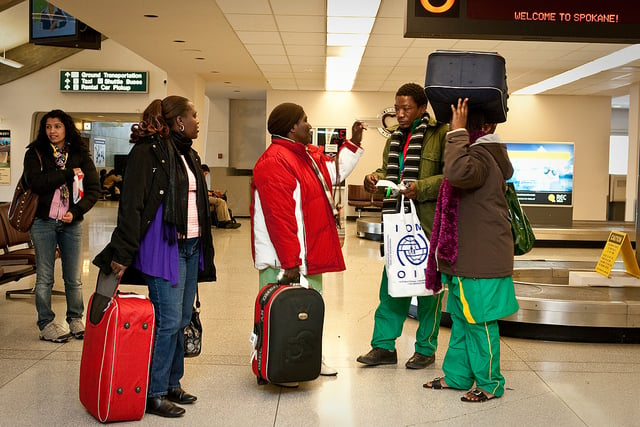 Congolese family arrives at an airport in Spokane, US, and are greeted by their caseworker and volunteers