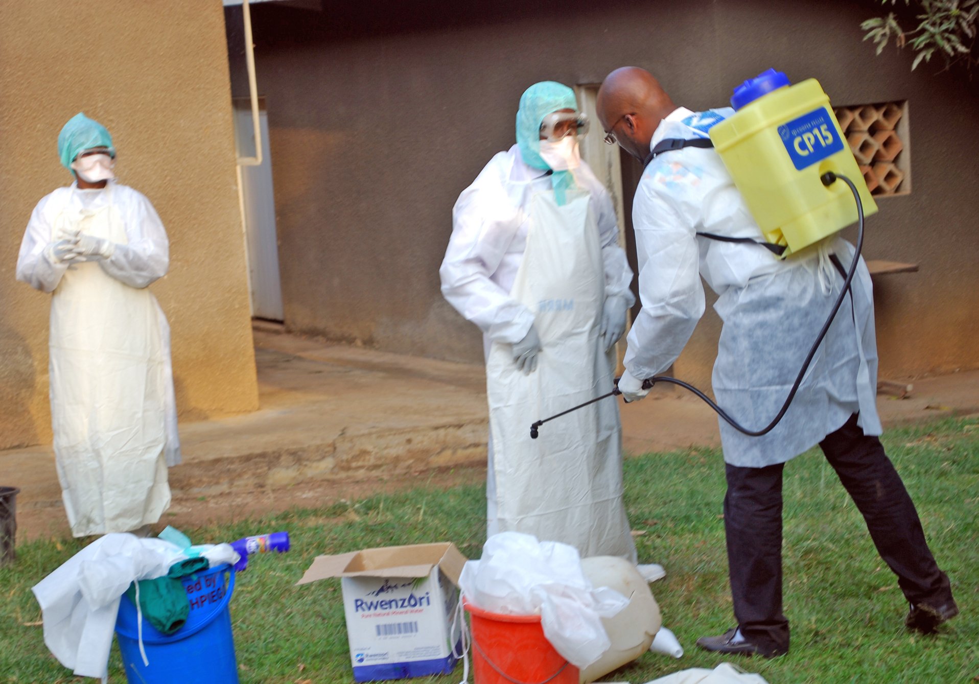 Doctor Yab Boun disinfecting colleagues before they investigate suspected Ebola cases at a new isolation centre at Mbarara Referral Hospital, south of the affected Kibaale district in western Uganda