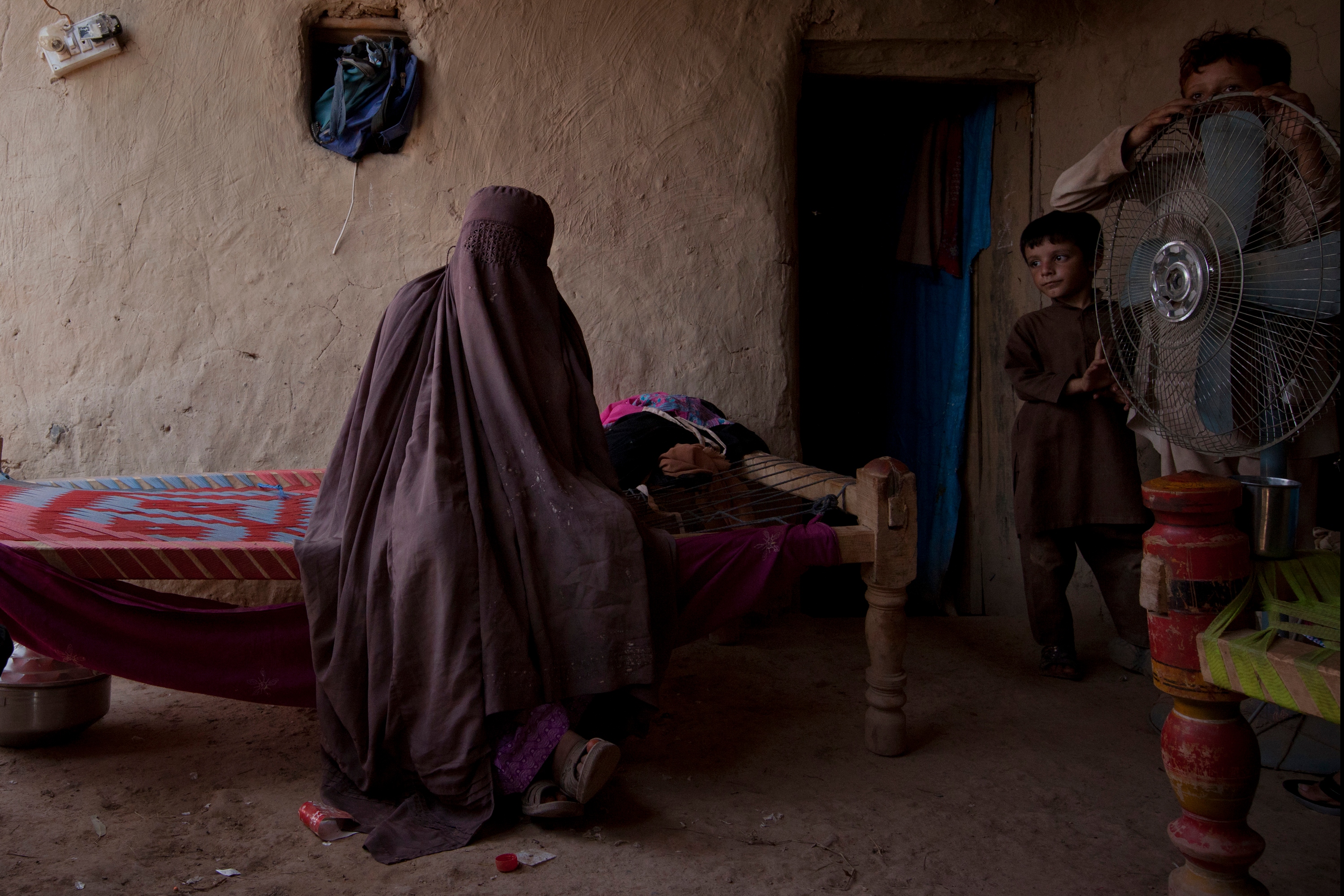 Anayatah Bibi, 35, is photographed with two children from her husband's second marriage at her house in the Jalozai refugee camp on August 30, 2012. Bibi is being treated for depression and violent episodes that often saw her beat her children, something 