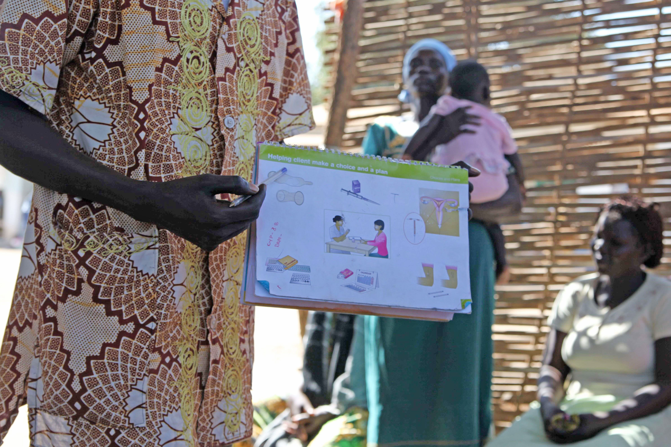 Health worker explaining birth control in Juba