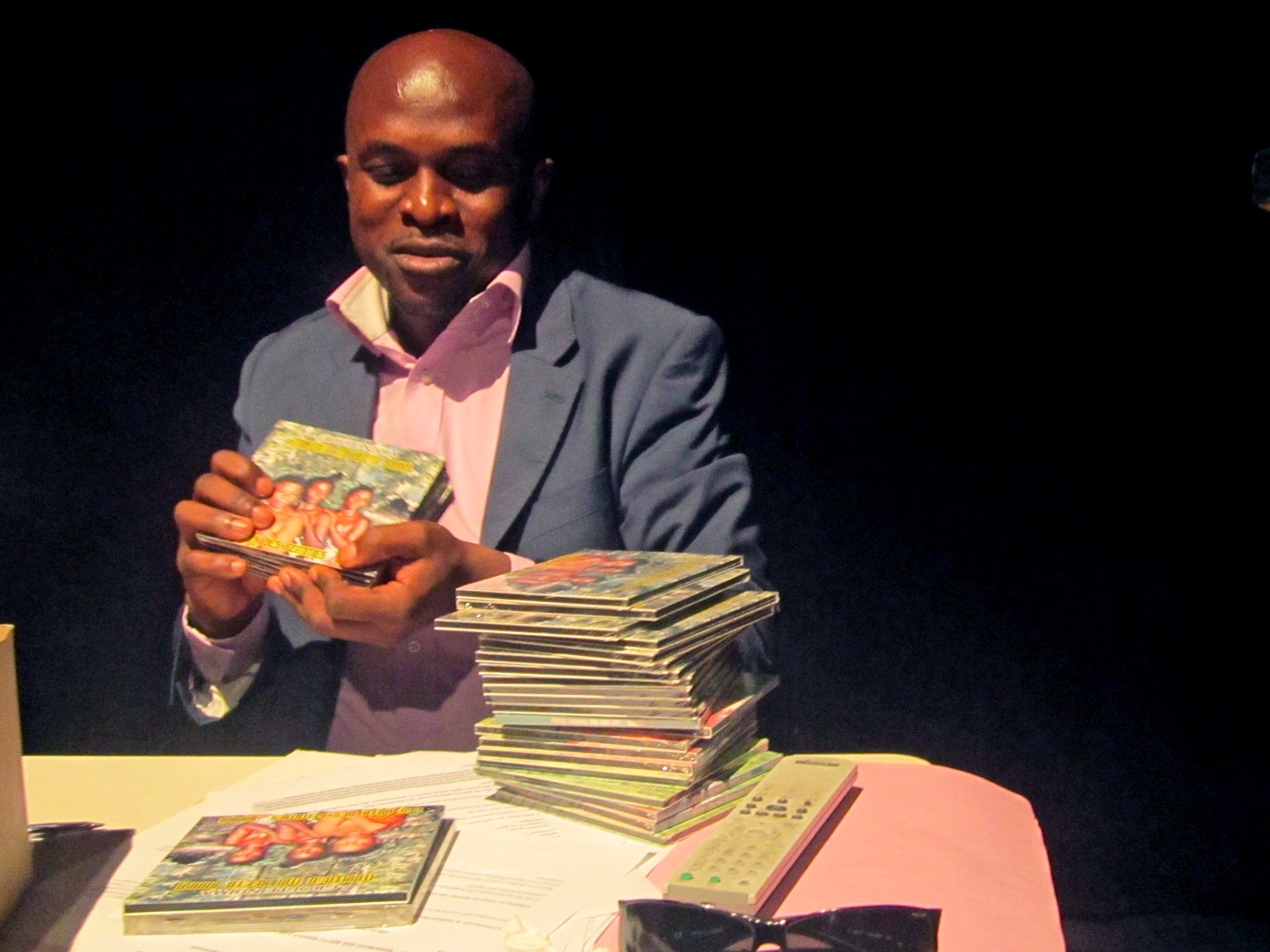 Congolese ethnologist displays a recently-released CD he produced of songs sung by the indigenous Baka community