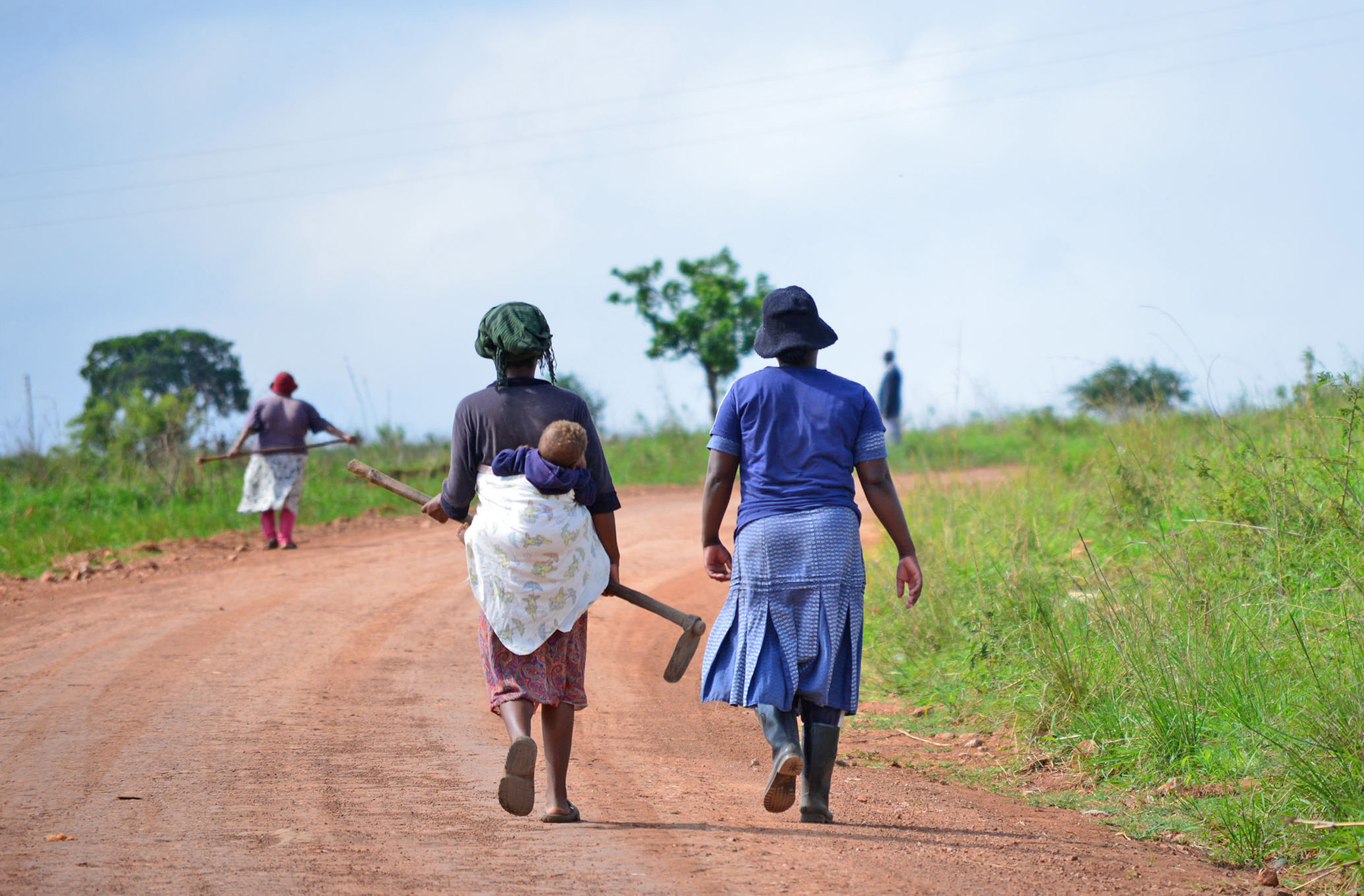 Women walk down a road in Swaziland's eastern Lubombo District. Much of the agricultural work in Swaziland is done by women