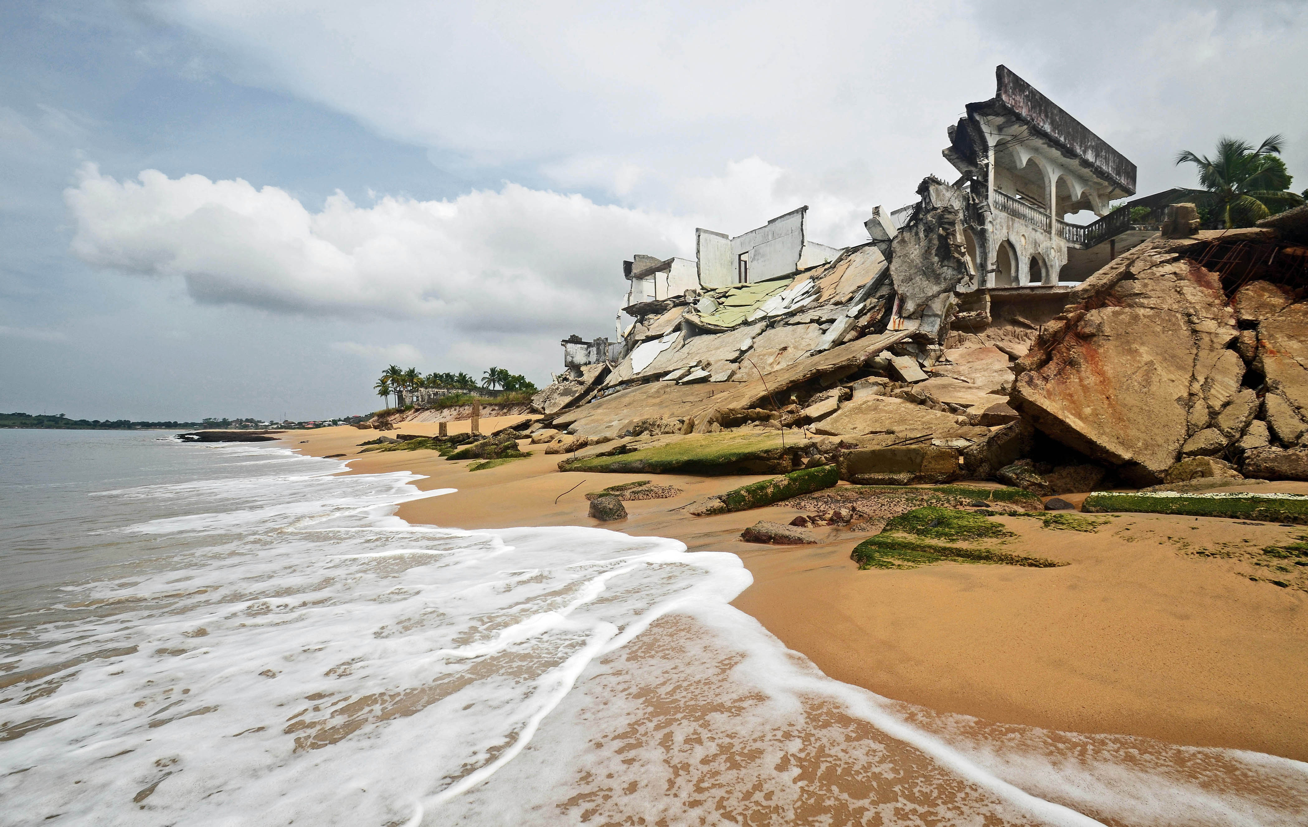 A string of destroyed buildings line Lakka Beach near Freetown, victims of coastal erosion after sand-mining began here in 2003 (Jan 2013) The coastline is drawing closer to homes along the beach