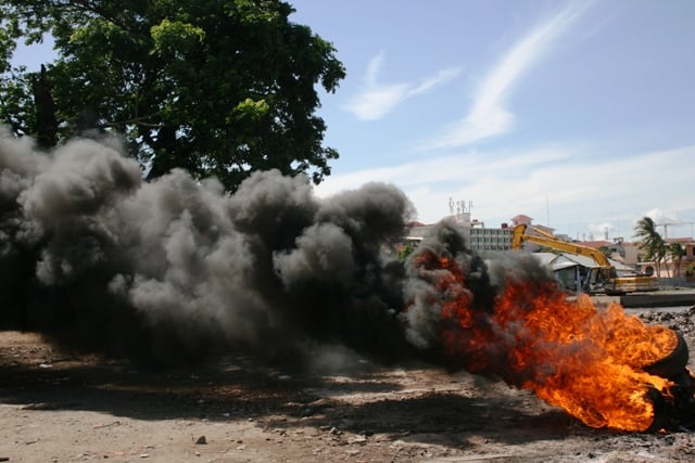 Tyres burn during a protest by residents from Phnom Penh's Boeung Kak lake area. Forced evictions are a major problem in the area