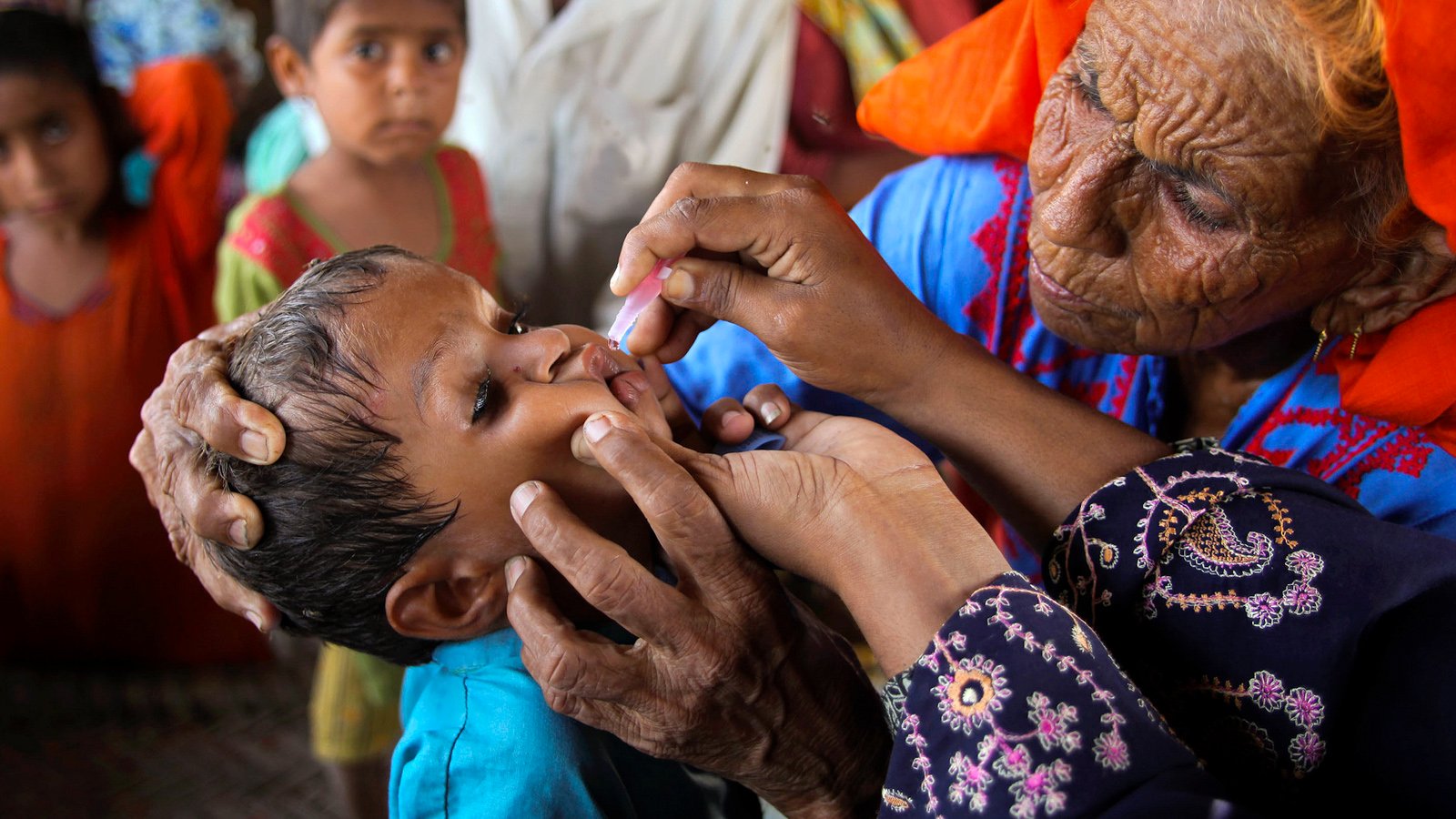 Pakistan turns up the heat on NGOs A lady health worker vaccinates a child against polio in flood-affected Sain Dad Katohar village in Khairpur district, Sindh province