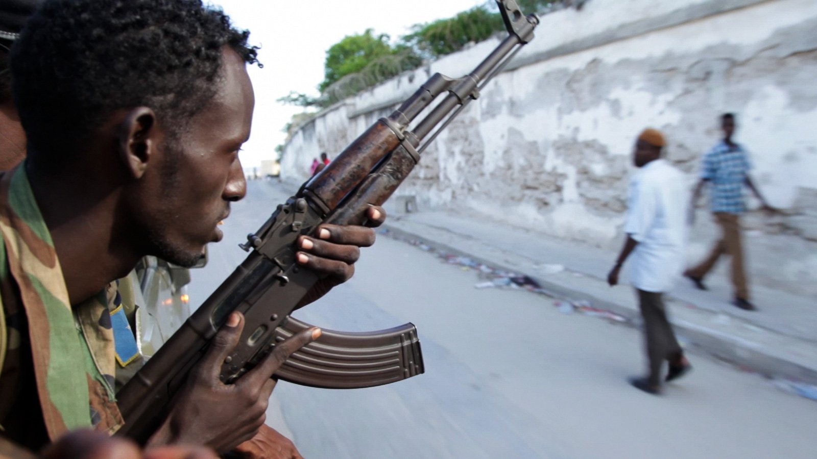 A soldier of the Somali National Army travels through the streets of Mogadishu, Somalia, in the back of a technical. The EU, Britain and other nations pledged significant funds for the reform of the Somali security forces at this year's London Conference 