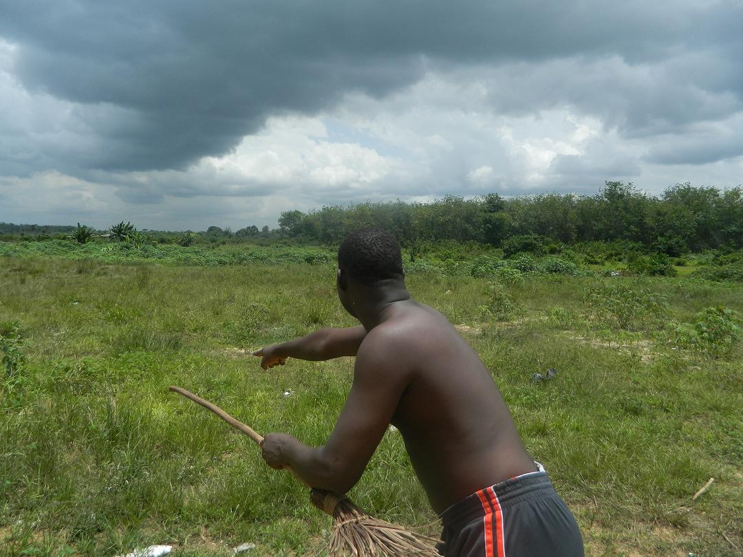 Harris Morris comes from Johnsonville, Liberia. He points out a plot of land that he claims is his but that was sold to someone else after he bought it (2013)