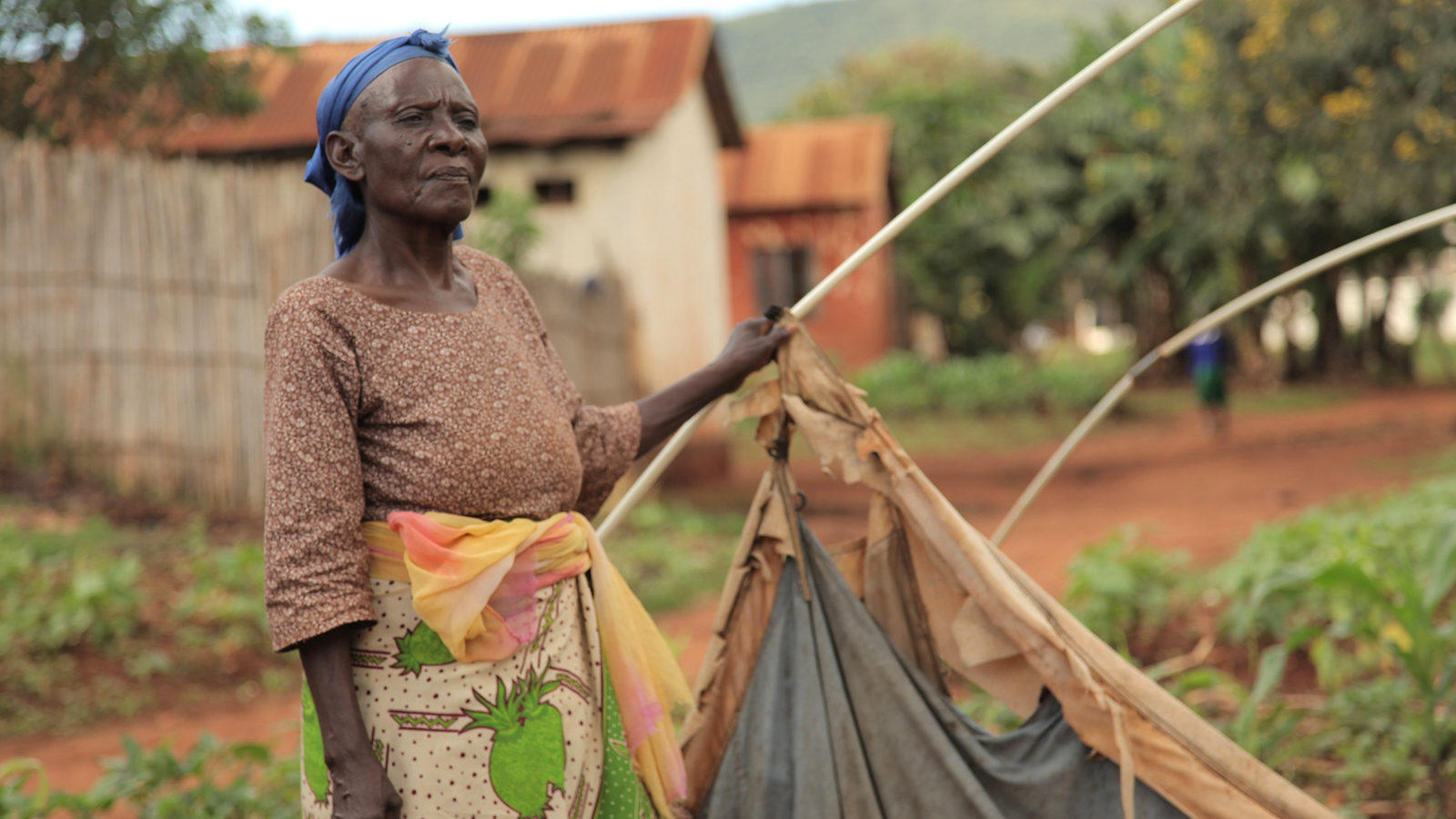 75 year old Mwajuma Hussein, a former farmer from Mine Mpya, sits inside her tent made of plastic sheeting