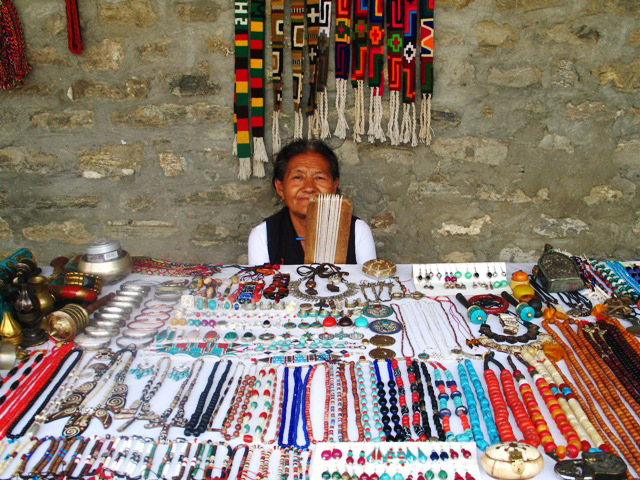 An old Tibetan woman sells souvenirs to western tourists for livelihood which is key source of income for many Tibetans but less tourists are buying. There an estimated 15,000 Tibetan refugees in Nepal, more than half of which are undocumented