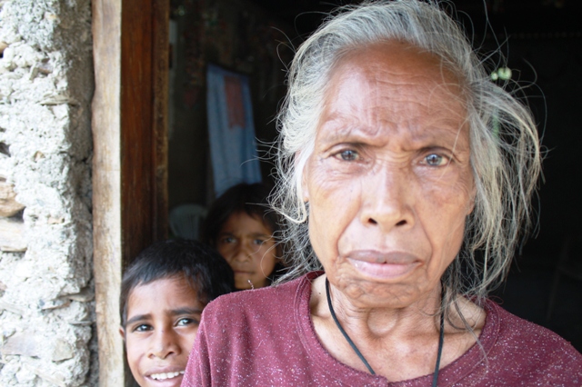 An elderly woman looks to the camera in rural Timor-Leste. In 2006, violence between gangs, members of martial arts groups, the police and the army resulted in more than 100,000 displace, many of whom sought protection in makeshift camps