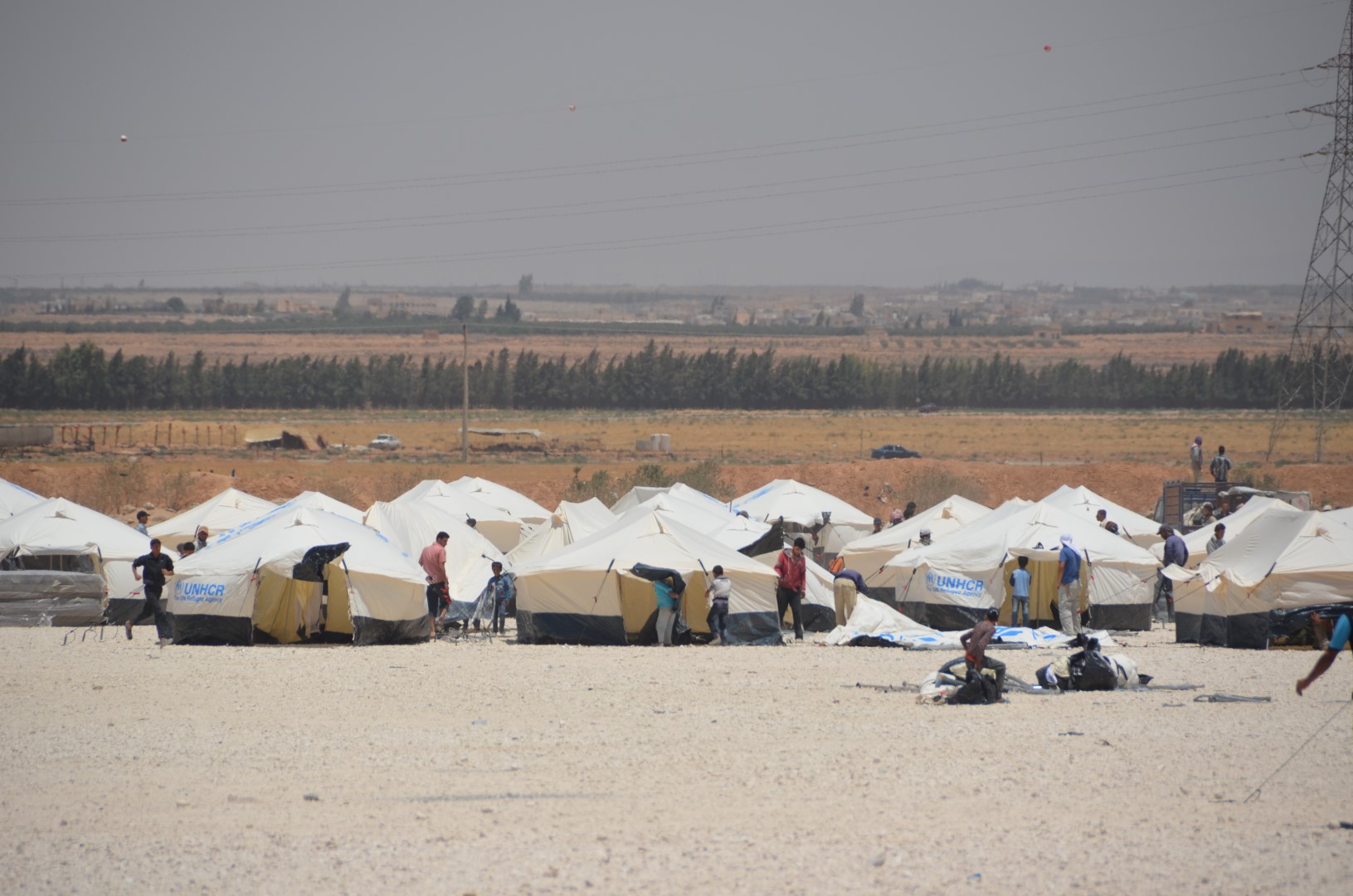 New arrivals set up their tents at Za'atari camp for Syrian refugees in northern Jordan. The camp is home to some 120,000 people who live in harsh desert conditions