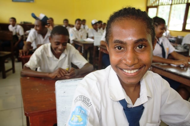 A young girl looks to the camera at a school outside Jayapura the provincial capital of Papua, Indonesia. The prevalence rate of HIV among Papua’s youth aged 15-24 is 3 percent 