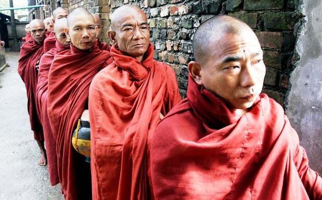 Buddhist monks on their morning rounds in a slum area of Yangon