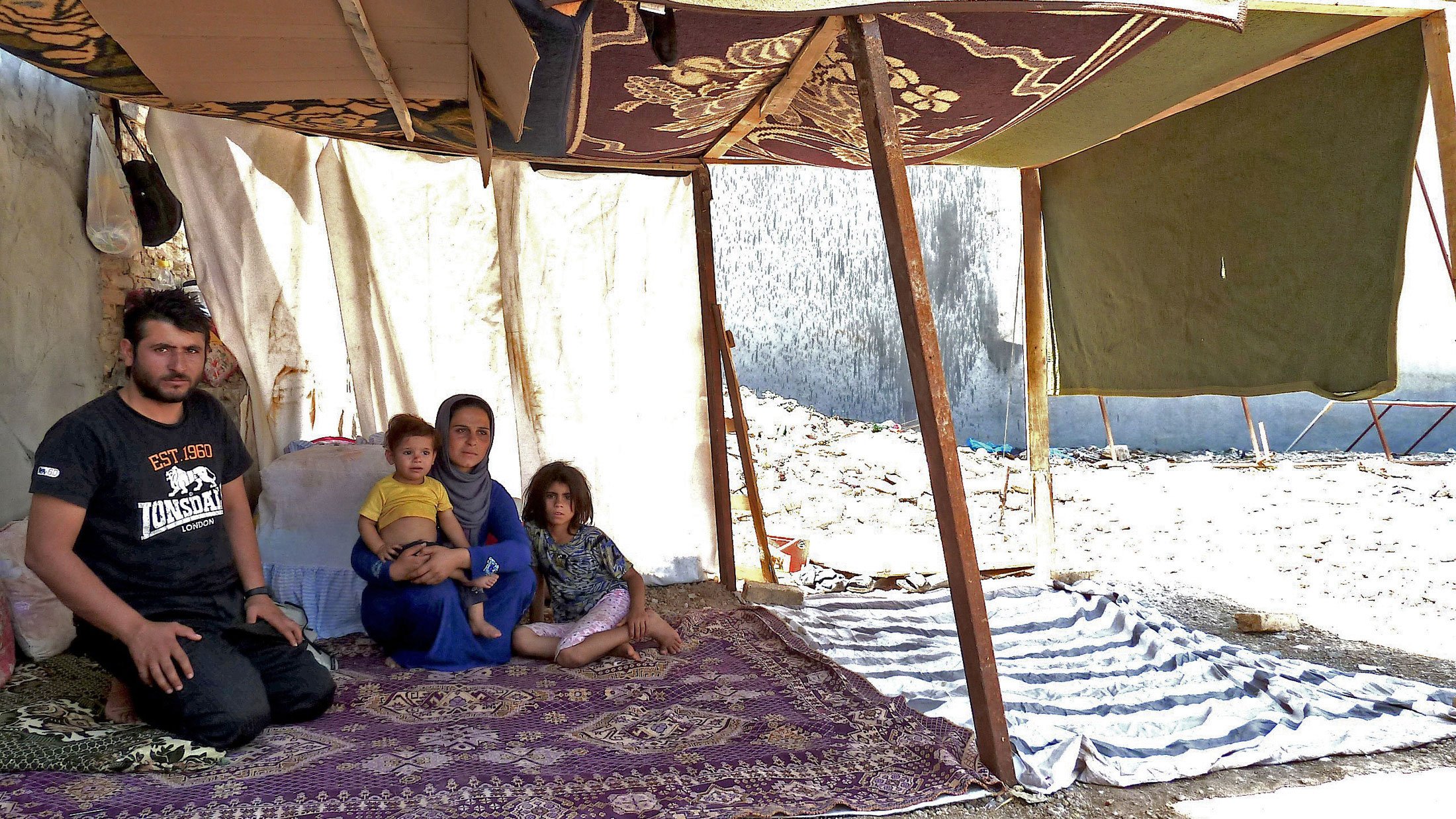 Syrian refugee Mohammed Hassan, 24, with his wife Guzel, 22, and their children in a make-shift tent on Shoresh Road in Erbil, the capital of the semi-autonomous Kurdish region of Iraq. Iraqi Kurdistan is sheltering 95 percent of the 161,000 Syrian refuge