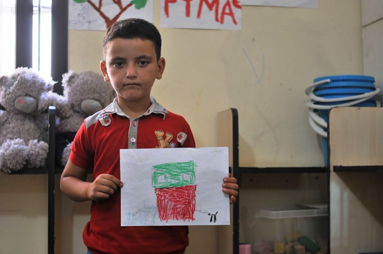 Ahmed, 9, left the Syrian city of Homs because of intense air bombing. He is now a refugee in Lebanon, where the NGO Najda Now has encouraged him to express himself through art. He has drawn the life he wants: a spacious house, a dog, and the sea