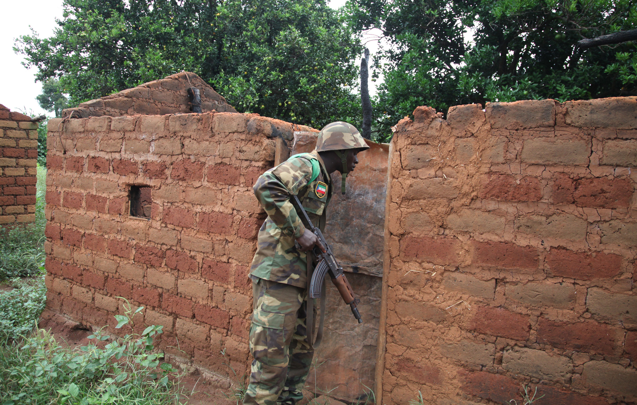 A regional peacekeeper checks an abandoned home in one of many
deserted villages lining the road south of Bossangoa