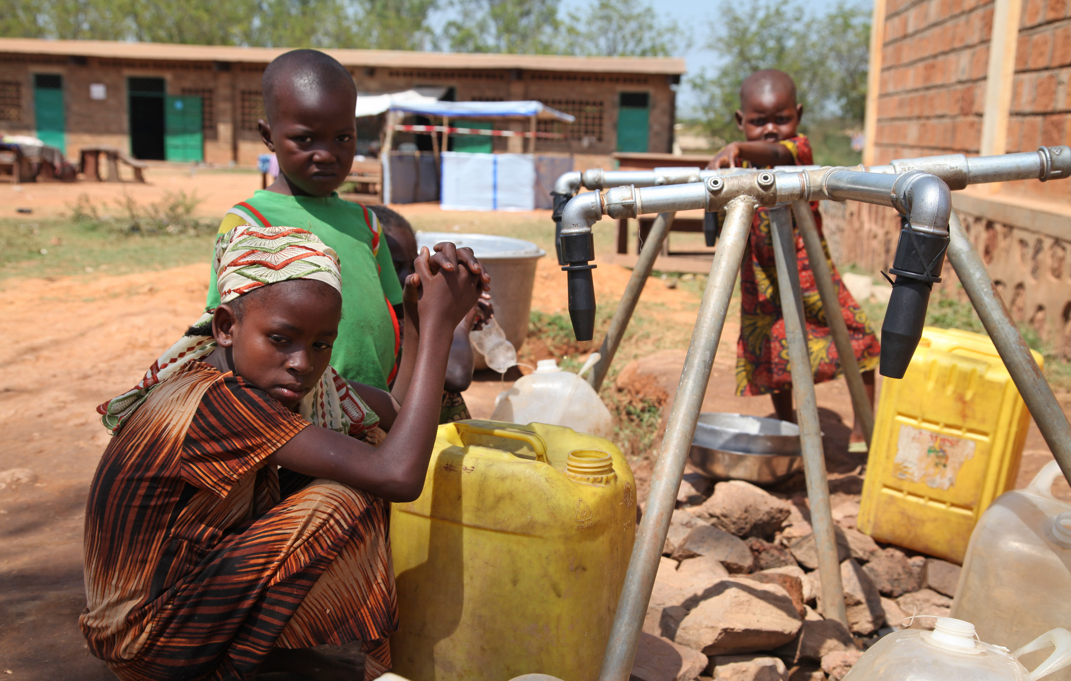 Children wait for water at a school where Muslims have sought shelter from increasingly brutal sectarian violence that has pitted largely Christian self-defence groups against Muslim rebels turned state forces and the wider community by association.