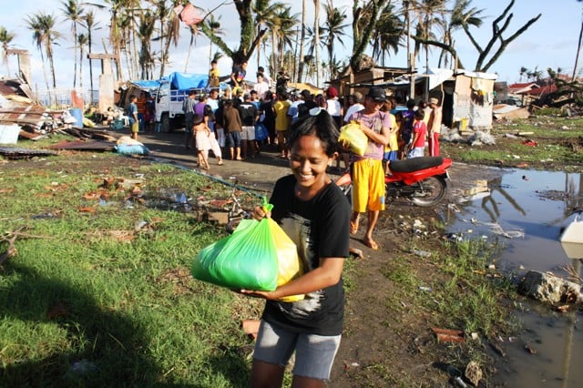 A young woman receives assistance in the typhoon-devastated town of Santa Rosa in Southern Leyte Province. More than 4 million people were displaced in the aftermath of Typhoon Haiyan, which slammed into the central Philippines on 8 November 2013