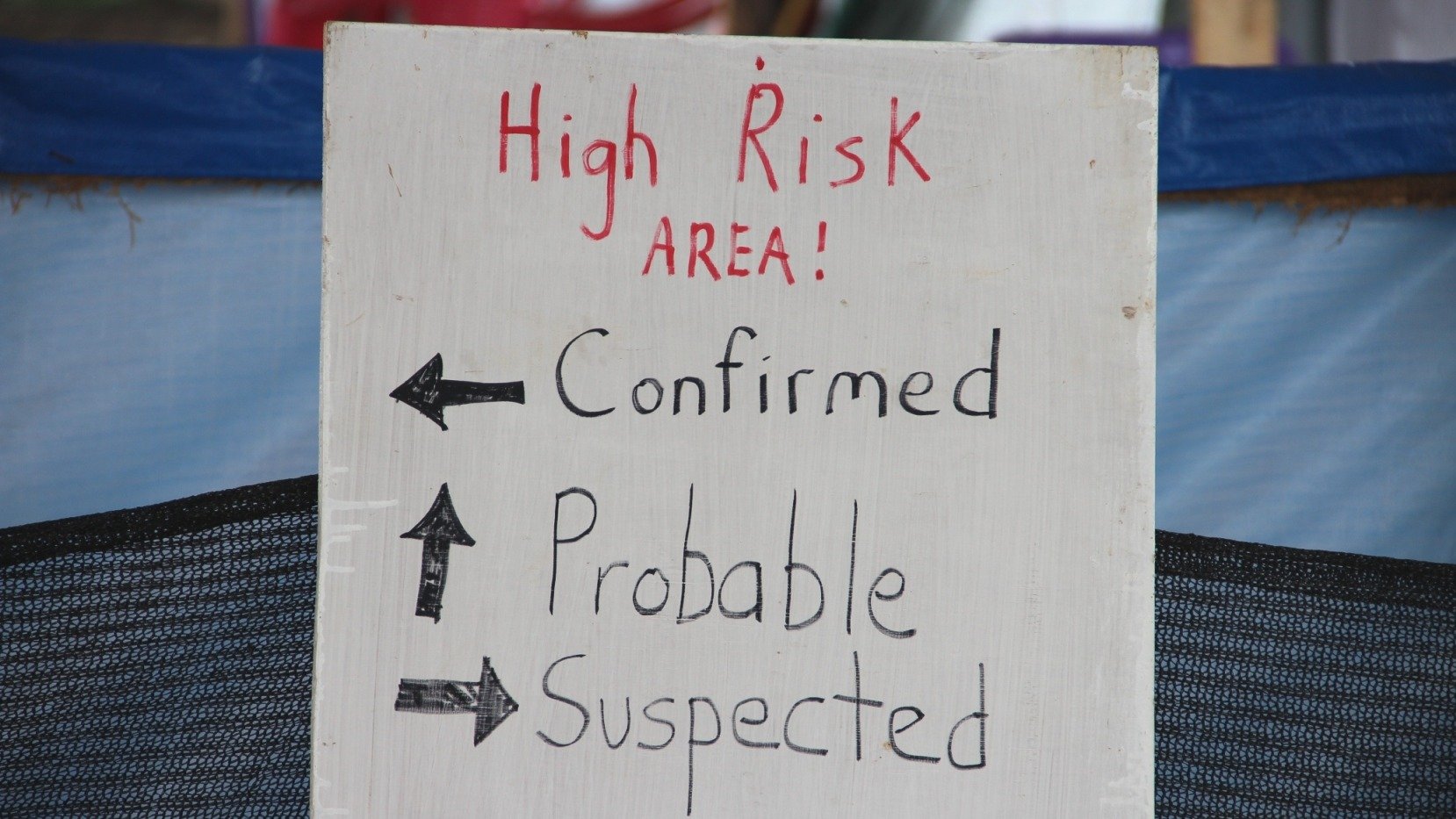 A sign indicating the three wards in the IFRC Ebola Treatment Centre outside of Kenema, Sierra Leone.